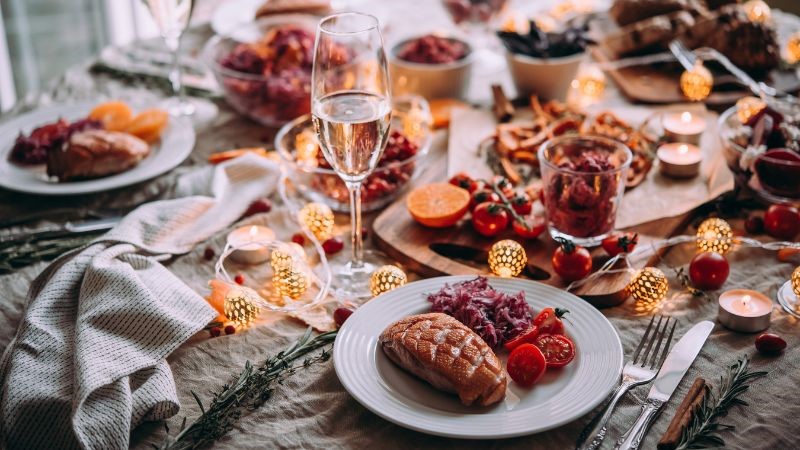 a christmas dinner is set with a glass of sparkling wine for whoever eats the food to celebrate with some fizz
