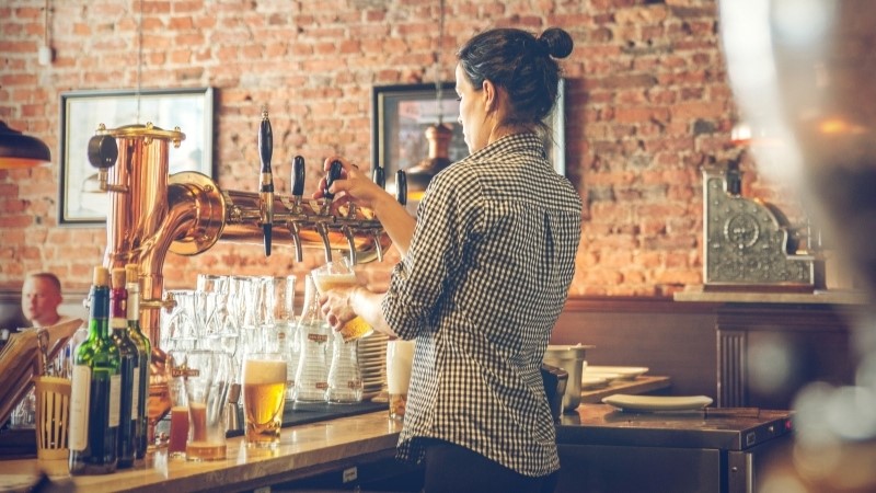 Image Of A Bartender Pouring A Pint Of Beer